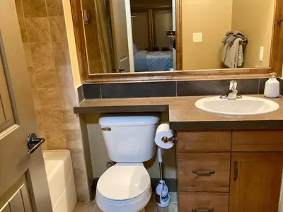a bathroom with a white toilet and a sink at Mountain View Retreat in Radium Hot Springs