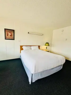 a bedroom with a large white bed in a room at Silver crest lodge in Grande Prairie