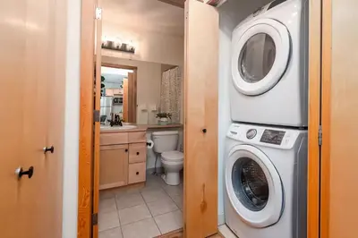 a bathroom with a washer and dryer at Rocky Mountain Oasis-Mountain View! in Canmore