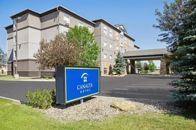 a sign in front of a building at Canalta High River in High River