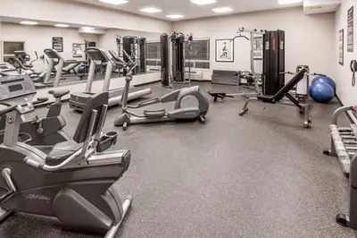 a gym with treadmills and elliptical machines at Canalta High River in High River