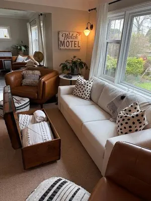 a living room with a white couch and a chair at Couple's Oasis at Horner Park in Victoria