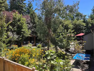 a garden with a wooden fence and flowers at Couple's Oasis at Horner Park in Victoria