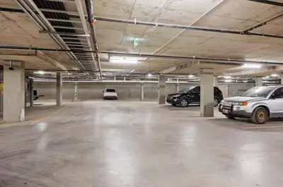 a parking lot with cars parked in a parking garage at Sparrowhawk Mountain Resort in Dead Man's Flats