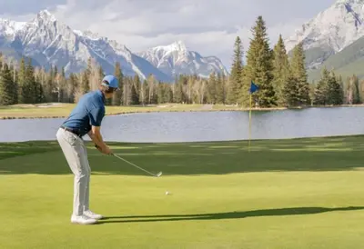a man playing golf in front of a lake at Sparrowhawk Mountain Resort in Dead Man's Flats