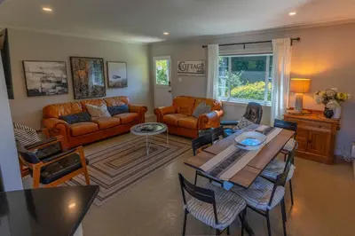 a living room with a couch and a table at Family Cottage at Horner Park in Victoria