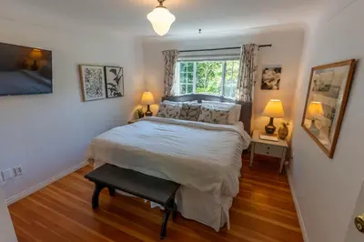 a bedroom with a large bed and a window at Family Cottage at Horner Park in Victoria