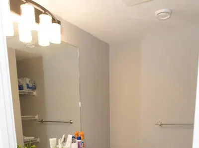 a bathroom with a large mirror and a sink at GoodVibes in Calgary