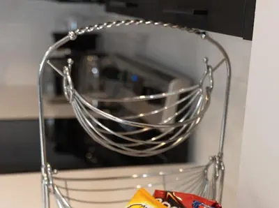 a metal wire basket in front of a microwave at GoodVibes in Calgary