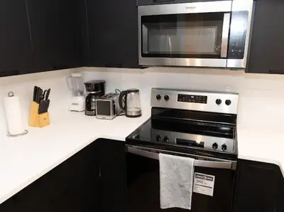 a kitchen with a stove and a microwave at GoodVibes in Calgary