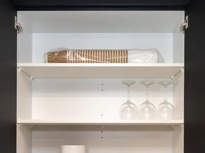 a white shelf with wine glasses and a bottle at GoodVibes in Calgary