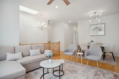 a living room with a couch and chairs and a table at Bright and Comfy 3BR Home Ideal for Families in Vancouver