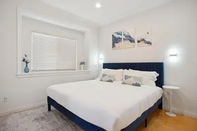 a bedroom with a large bed and a window at Bright and Comfy 3BR Home Ideal for Families in Vancouver