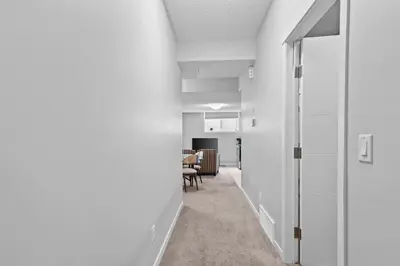 an office corridor with white walls and a table at Spacious 2BR Suite - SW Edmonton in Edmonton
