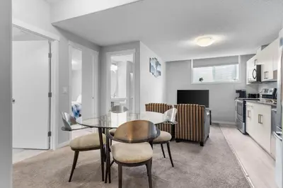 a kitchen and dining room with a table and chairs at Spacious 2BR Suite - SW Edmonton in Edmonton