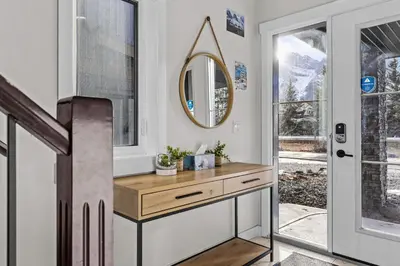 a hallway with a dressing table and a mirror at Township by Canmore Premier in Canmore