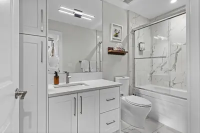 a white bathroom with a sink and a toilet at Township by Canmore Premier in Canmore