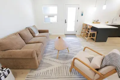 a living room with a couch and a table at Aurelia Guest Suite and Sauna in Tofino