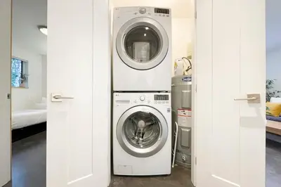 a washing machine and a washer and dryer in a room at Tidal Retreat Cabin in Tofino