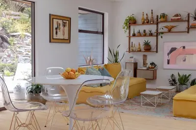 a living room with a white table and chairs at The Cougar Den in Tofino