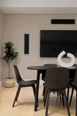 a dining room with a table and chairs and a flat screen tv at Charming Luxury Home near DT and Lonsdale Quay in North Vancouver