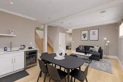 a kitchen and living room with a table and chairs at Charming Luxury Home near DT and Lonsdale Quay in North Vancouver