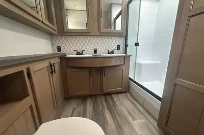 a small bathroom with a sink and a tub at Fernie RV Resort in Fernie