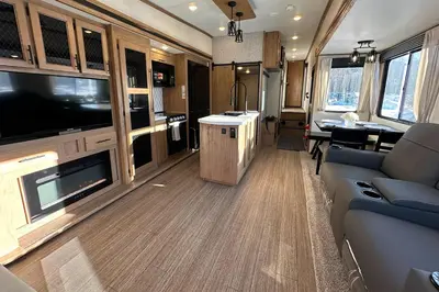 an rv living room with a couch and a tv at Fernie RV Resort in Fernie