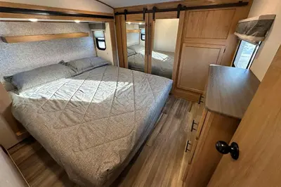 a small bedroom with a bed in an rv at Fernie RV Resort in Fernie