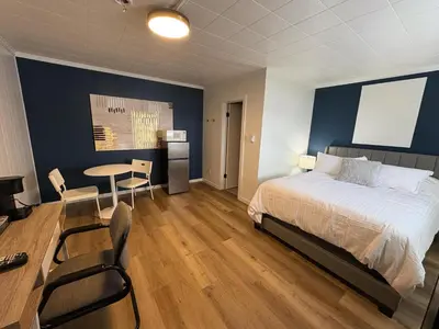a bedroom with a bed and a table and chairs at Remo Stays in Unity