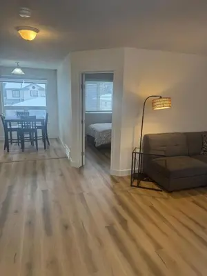 a living room with a couch and a table at Alpenglow Oasis in Hinton