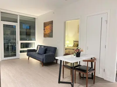 a living room with a table and a chair at Best location &comfortable room1B &1B Richmond center in Richmond