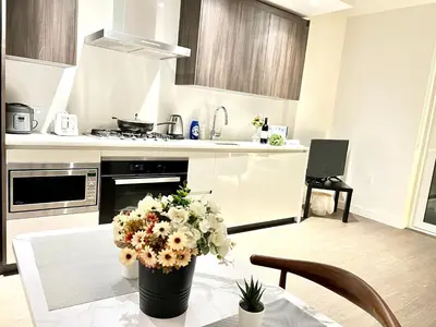 a kitchen with a table with a vase of flowers on it at Best location &comfortable room1B &1B Richmond center in Richmond