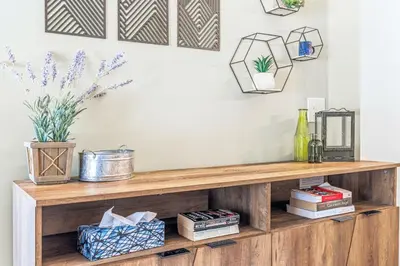 a wooden shelf with books and plants on it at Scenic 2BR Haven with MTN Views Near DT Banff in Canmore