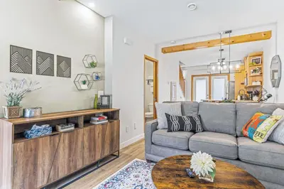 a living room with a couch and a table at Scenic 2BR Haven with MTN Views Near DT Banff in Canmore