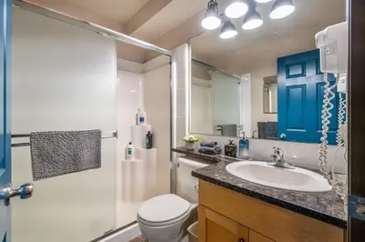 a bathroom with a sink and a toilet and a shower at 2BR Mystic Springs Escape with BBQ, Pool, Hot tub in Canmore