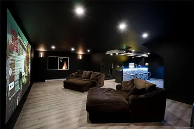 a large living room with two couches and a tv at Shawnigan Lake Retreat with Theatre in Shawnigan Lake