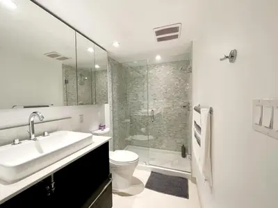 a bathroom with a sink and a toilet and a shower at #Modern & Cozy 2BR 2BA in the Heart of Chinatown in Vancouver
