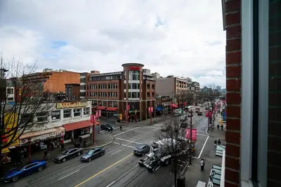 a busy city street with cars on the road at #Modern & Cozy 2BR 2BA in the Heart of Chinatown in Vancouver