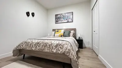 a bedroom with a bed in a white room at Birdie on the Hill in Mission City