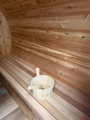 a wooden tub sitting in a sauna at The Royal Ravine Luxury Retreat with Hot Tub & Sauna in Calgary