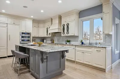 a kitchen with white cabinets and a large island at The Royal Ravine Luxury Retreat with Hot Tub & Sauna in Calgary