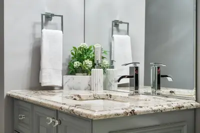 a bathroom with a sink and a mirror at The Royal Ravine Luxury Retreat with Hot Tub & Sauna in Calgary