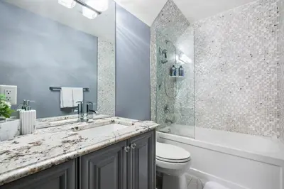 a bathroom with a sink and a toilet and a shower at The Royal Ravine Luxury Retreat with Hot Tub & Sauna in Calgary