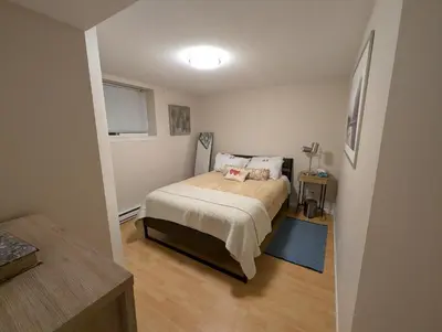 a small bedroom with a bed and a window at Walnut Grove Gem in Langley