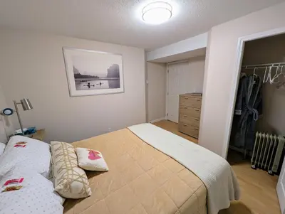 a bedroom with a bed and a dresser in it at Walnut Grove Gem in Langley
