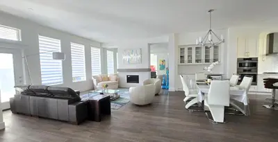 a living room with a couch and a table at Peaceful Coquitlam Escape, Modern New Home, Minutes to Transit in Coquitlam
