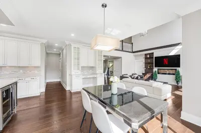 a kitchen and living room with a table and chairs at Sunnymede Vacation Stay in Richmond