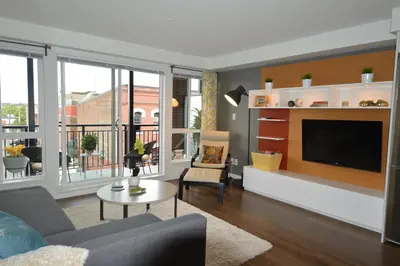 a living room with a couch and a tv at Be Close To Chinatown When You Are In The Union Building in Victoria