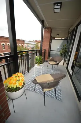 a balcony with a table and chairs and flowers at Be Close To Chinatown When You Are In The Union Building in Victoria
